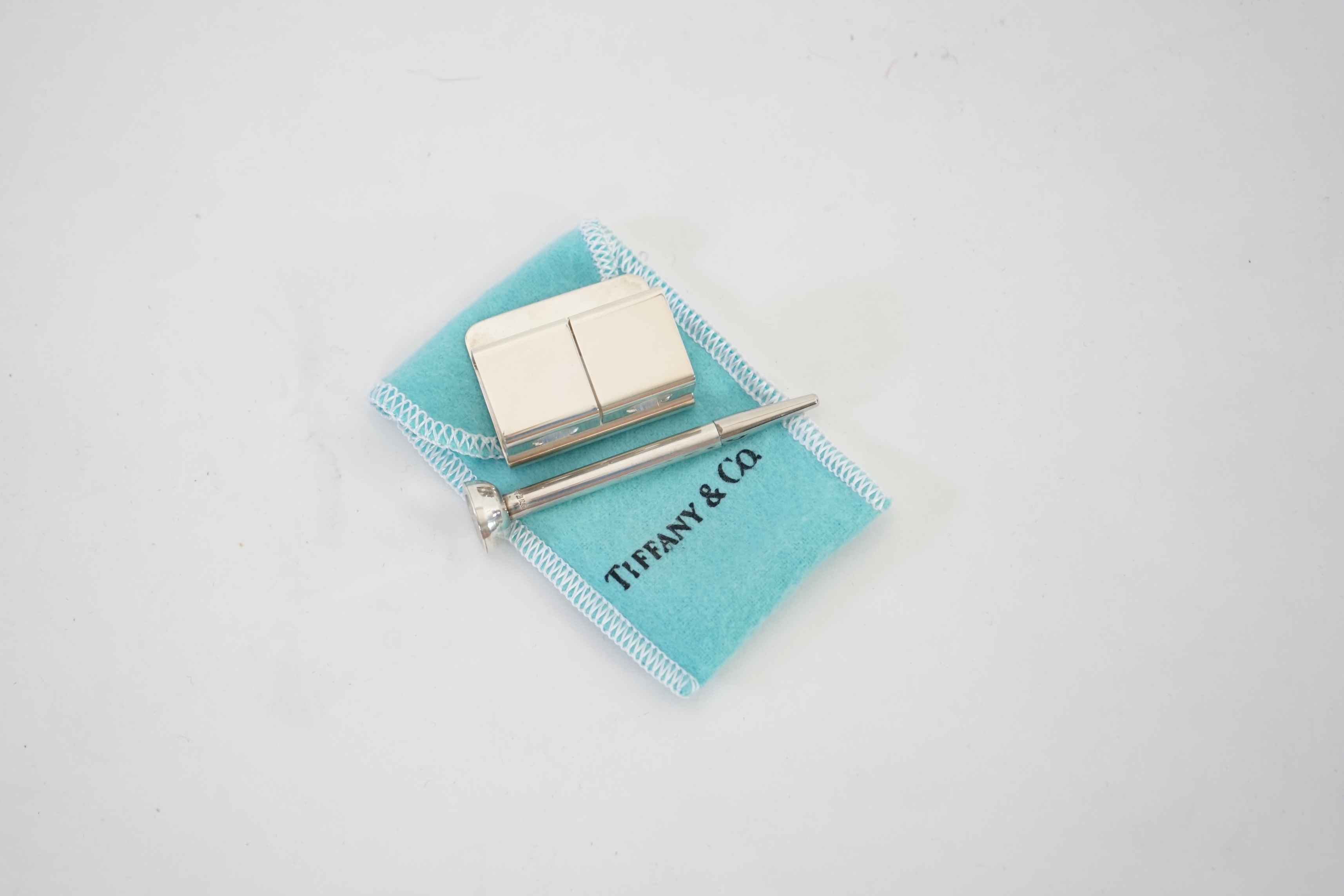 A Tiffany & Co. golf tee holder and pencil